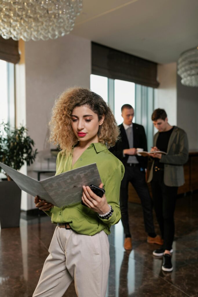 Business professionals in a modern office environment, reviewing documents with focus and collaboration.